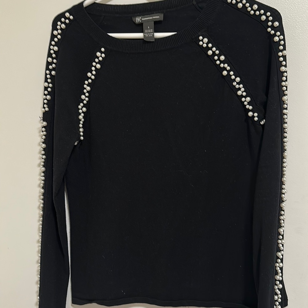 black sweater with white pearl details